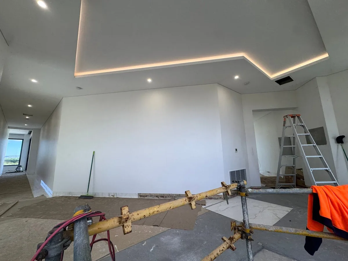 Ceiling bulkhead and concealed LED lighting being installed during a fit-out