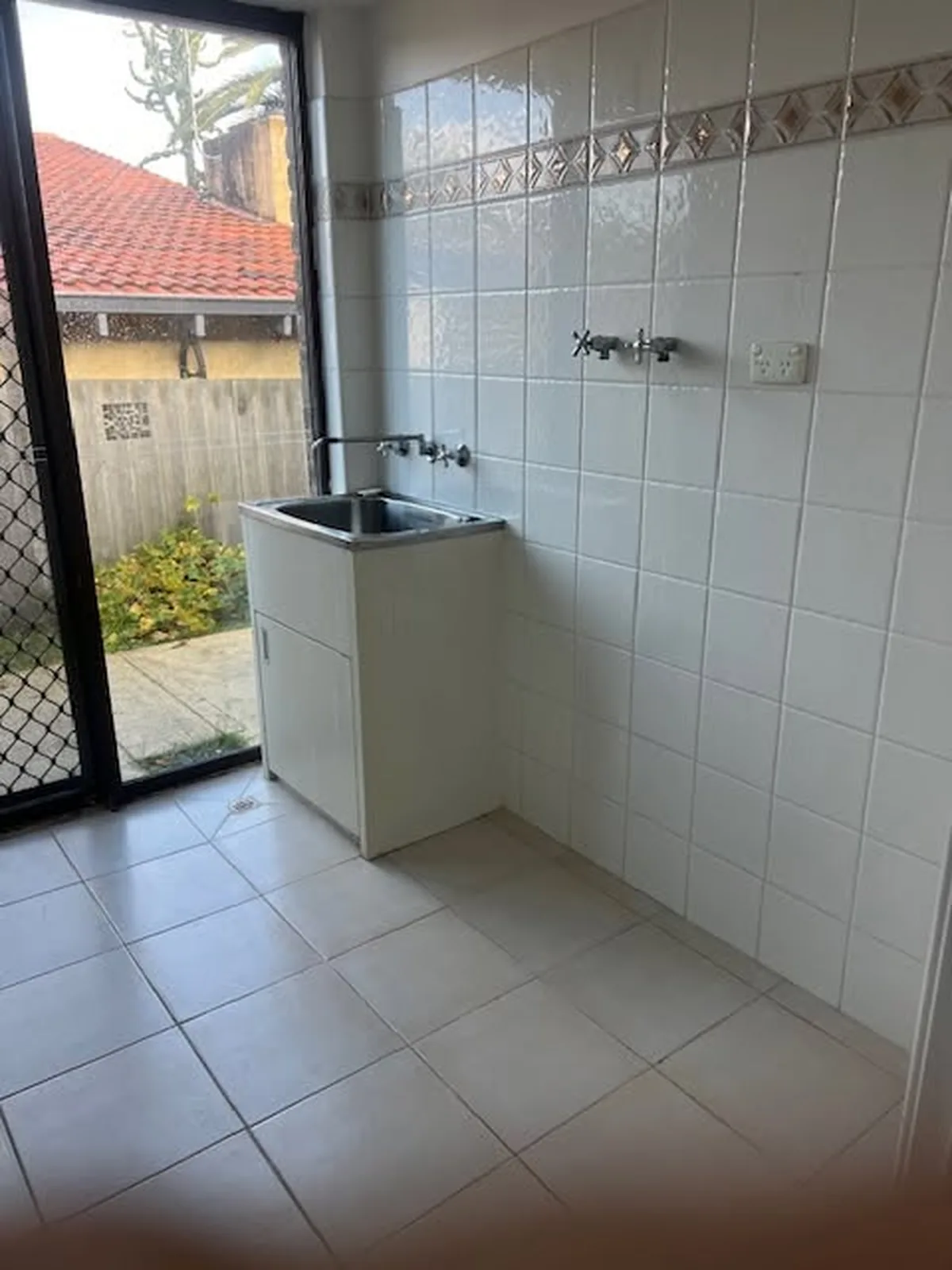Laundry trough, wall taps and power point cleaned down during a rental turnover